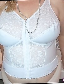 Hot mature brunette shows off her pantyhose clad pussy by lifting her skirt