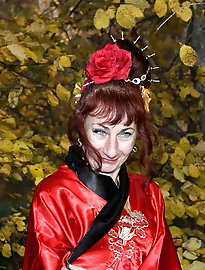 Older hellcats are posing naked outdoors