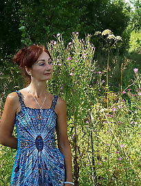 In blue dress in field