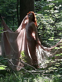 Aroused older girl is taking off her bra for a photoshoot