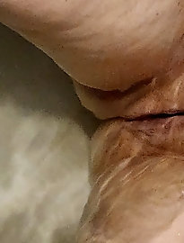 A plump woman is opening her legs